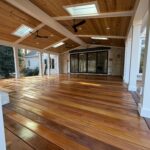 Covered porch with stained ceiling, painted beams and stained deck